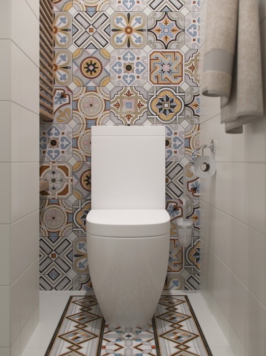 Орнаменты кафельной плитки в туалете образуют ковер на полу и стене.